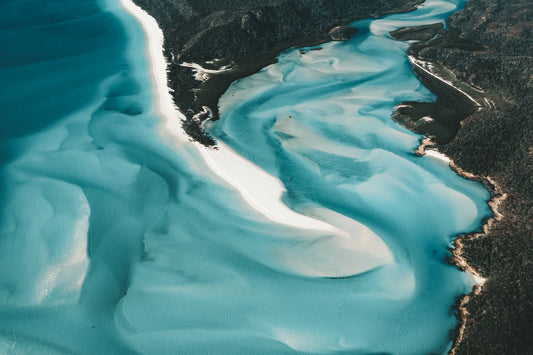 An aerial view of the Great Barrier Reef in Australia, showcasing the vibrant coral formations and crystal-clear turquoise waters of one of the world's most beautiful natural wonders.